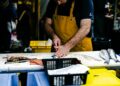 Brixton Market a Caribbean shoppers route photo 1 - LONDONwebzine Fishmonger serving a customer at Brixton Market's Electric Avenue stalls