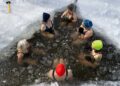 Woman stepping into a cold plunge pool at a Hackney studio
