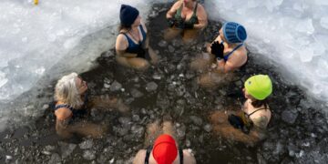 Woman stepping into a cold plunge pool at a Hackney studio