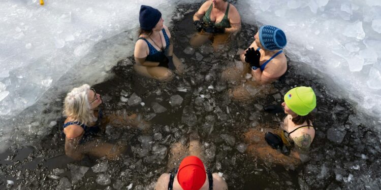 Woman stepping into a cold plunge pool at a Hackney studio