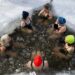 Woman stepping into a cold plunge pool at a Hackney studio
