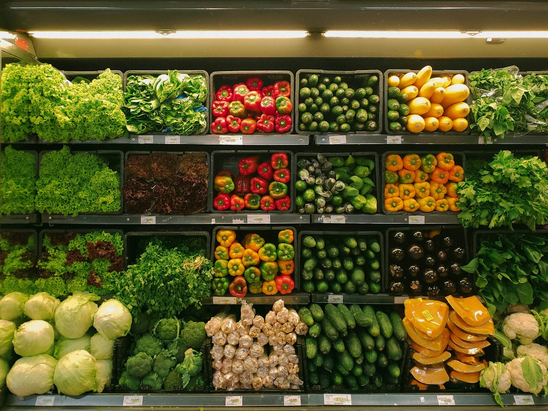 Shopper choosing plantain and scotch bonnets at a Brixton Market grocer
