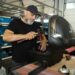 Volunteer fixer at a London repair cafes session mending a small appliance
