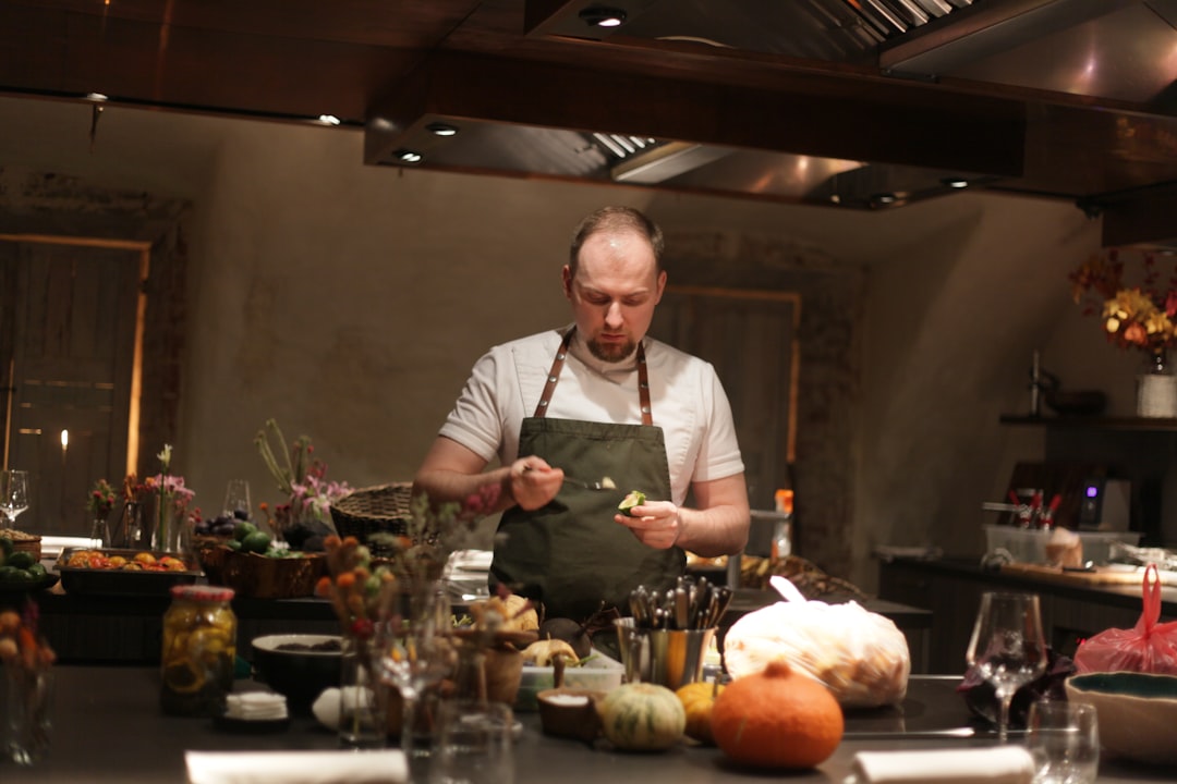 A chef cooking a Sunday roast around a table inside a cosy London gastropub