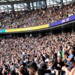 Diverse fans in the stands at The Oval experiencing the cricket economy of a live England Test match in south London