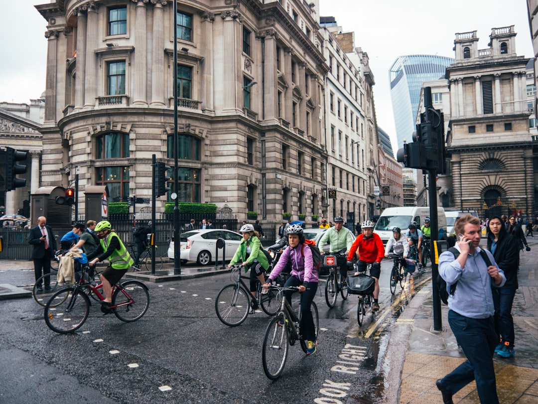 A group of beginners setting off on a road cycling club ride through a London park on a sunny morning