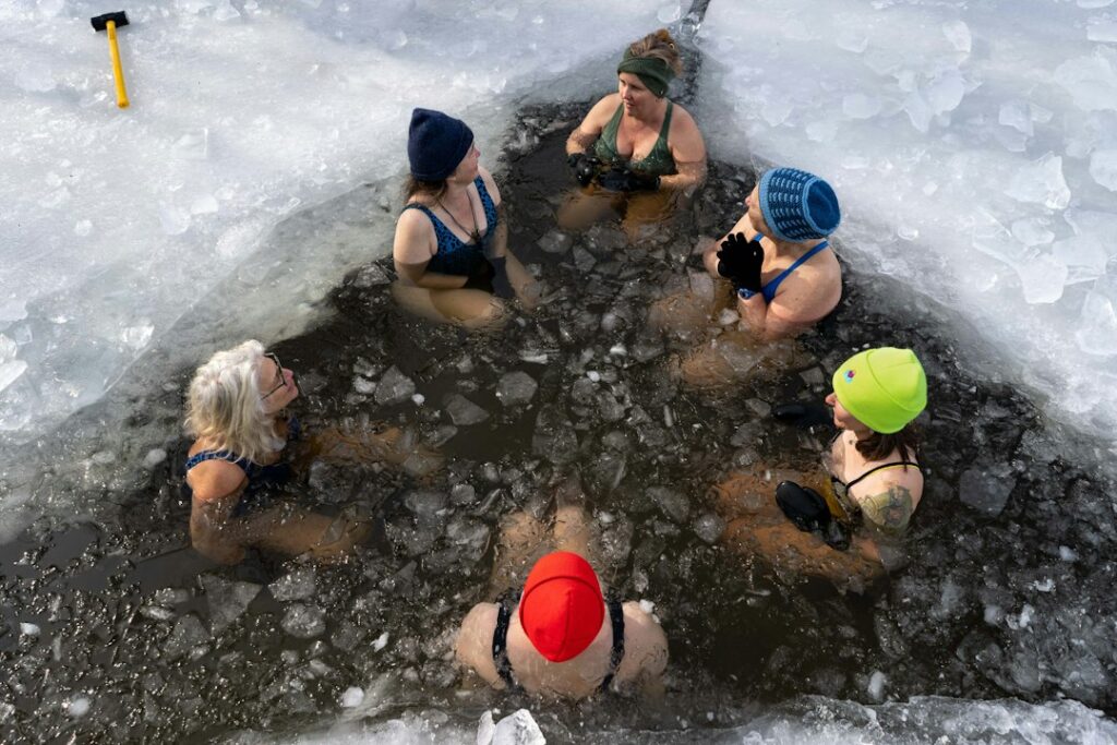 Woman stepping into a cold plunge pool at a Hackney studio